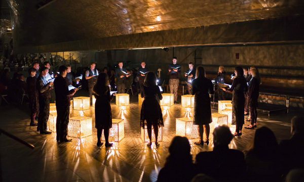 A photograph of the ORA singers in concert.