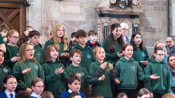 Schoolchildren singing on a stage