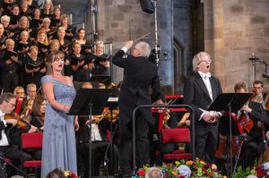Soloists and the Festival Chorus performing on stage.