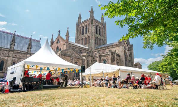 A view of marquees in front of Hereford Cathedral, sunny.