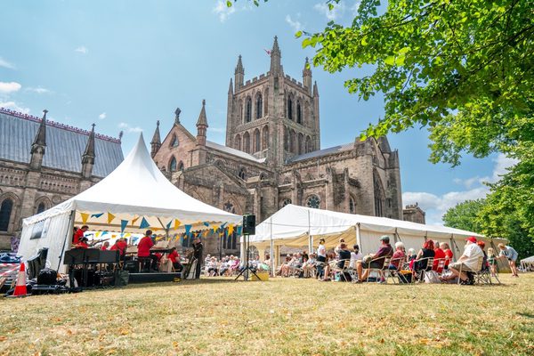 A view of marquees in front of Hereford Cathedral, sunny.