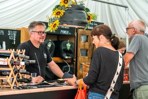 People ordering drinks in a marquee bar