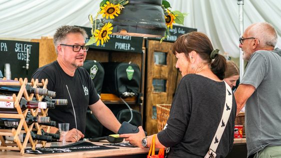People ordering drinks in a marquee bar