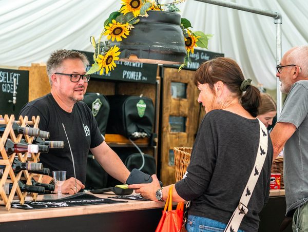 People ordering drinks in a marquee bar