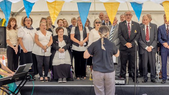 People singing on the bandstand.