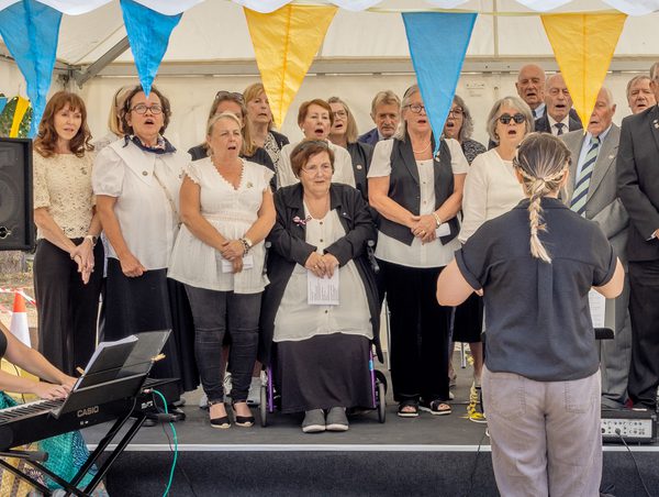 People singing on the bandstand.